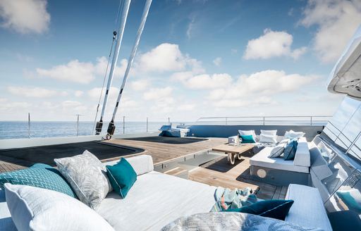 Exterior lounge area onboard S/Y GREY B, with ample seating around the deck and surrounding views of the sea.