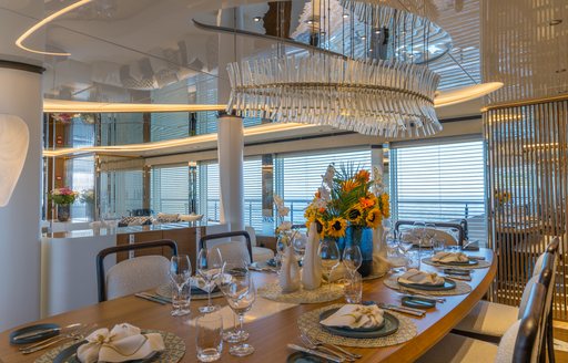 Interior dining area onboard charter yacht ETERNAL SPARK with sunflowers on the table