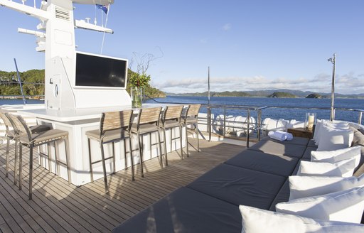 bar with TV and bar stools on the sundeck of luxury yacht RELENTLESS 