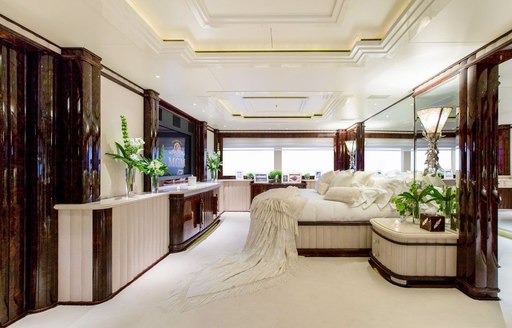 Master cabin onboard Charter yacht 'Lioness V', central berth on starboard side facing flat screen TV, surrounded by windows