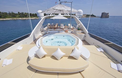 Sun deck of motor yacht BRUNELLO with sun pads and spa pool in foreground