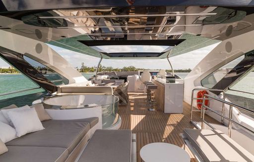 Charter yacht THE PEDDLER exterior seating area with shade from hardtop