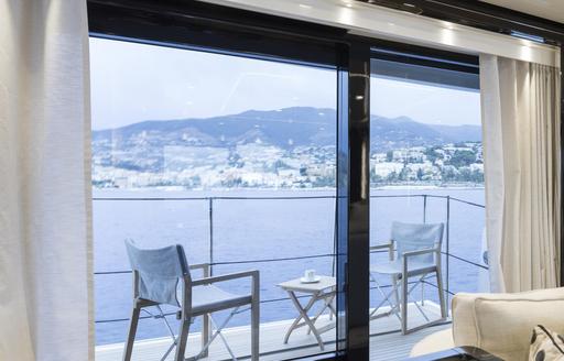 Charter yacht ANDIAMO fold-down balcony with seating arrangement