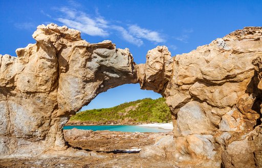 A rocky formation against a bright blue sky