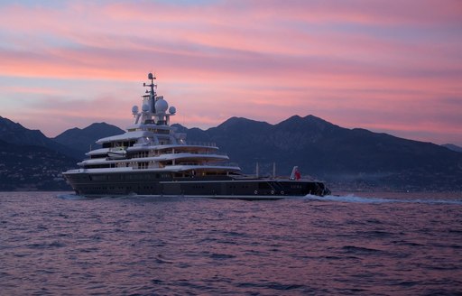 pink sunset skies over luxury yacht luna