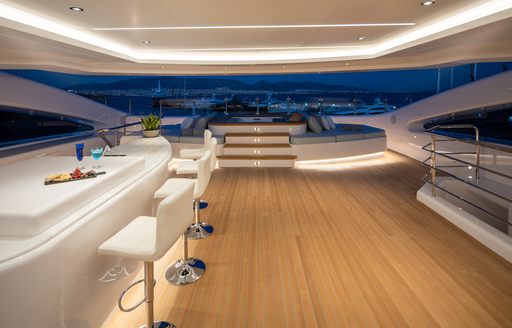 Bar area on superyacht O'PARI with Jacuzzi in background and teak decking visible