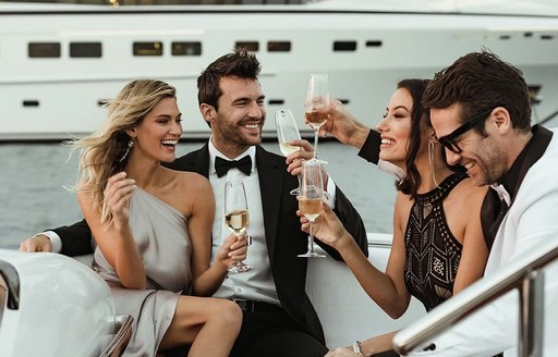 Guests enjoy champagne on board charter yacht SECRET