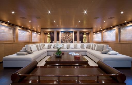 huge u-shaped sofa in main salon of luxury yacht MISCHIEF 