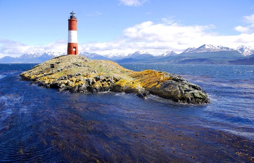 A lighthouse perches atop a rock in New England USA