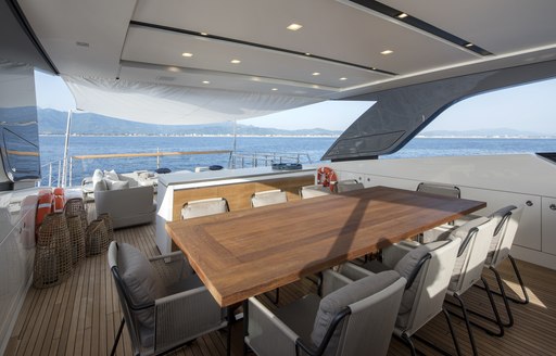 al fresco dining table on the flybridge of charter yacht DINAIA 