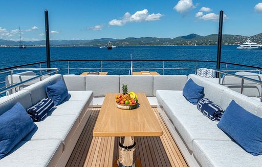 Exterior seating and table onboard charter yacht ARSANA