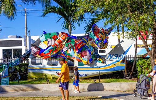 A colored sculpture of a cat along the streets of Miami as part of the Art Basel Miami exhibit