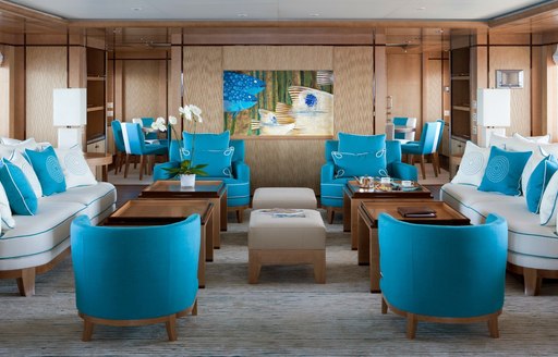 Blue and white furnishings inside the main salon of luxury yacht Ramble On Rose