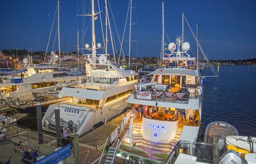 Luxury yachts during Newport Yacht Charter Show, illuminated at night