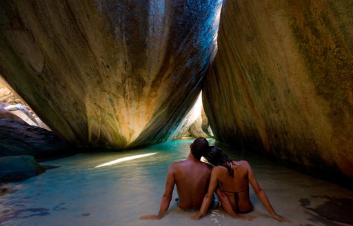 Couple of charter guests sitting in The Baths, BVIs