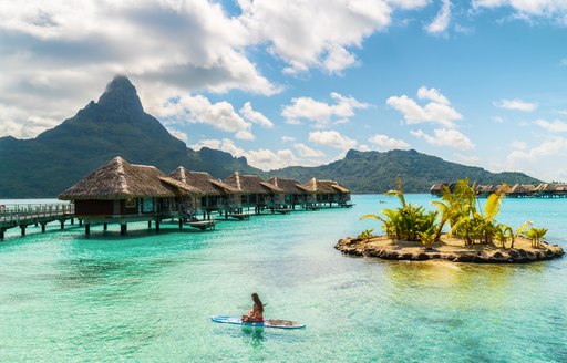 A woman on a paddleboard in tahiti