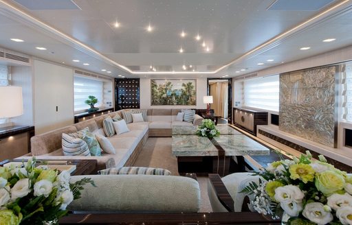 Main salon onboard boat charter SCORPION with cream sofas and a coffee table