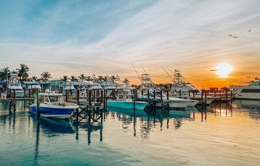 Sunset over the marina where small boats and yachts are docked