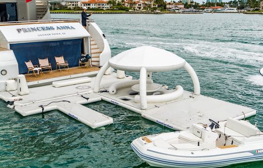 Overview of the aft decks of charter yacht ARTEMISEA, along with inflatable water toys and a tender