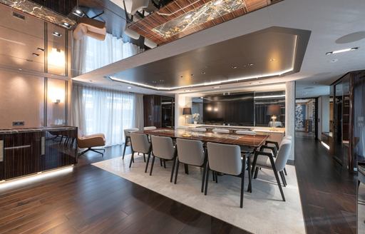 Charter yacht ROSE D'OR interior dining area with long table and large window