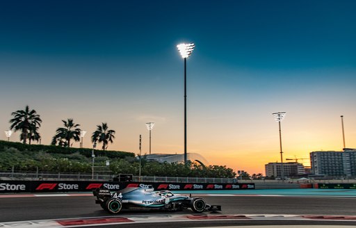 lewis hamilton in his formular 1 car racing the abu dhabi grand prix track before he scored his 11th win this season