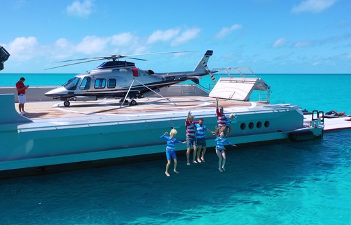 charter guests jump off the deck of luxury yacht BOLD