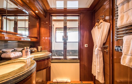 Ensuite on Superyacht Queen of Sheba with sink and dressing gown visible