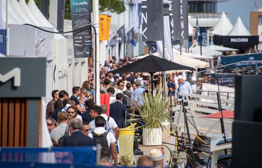 Monaco Yacht Show line of exhibitors with many visitors exploring