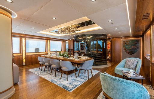 Interior dining area on luxury charter yacht ARESTEAS, with chandelier on ceiling 