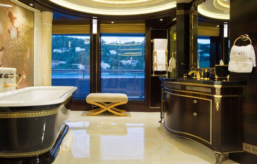 Private master cabin bathroom with tub to port and large sink unit onboard charter yacht WHISPER