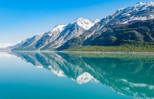 Mountains reflecting in still water, Glacier Bay National Park, Alaska, United States