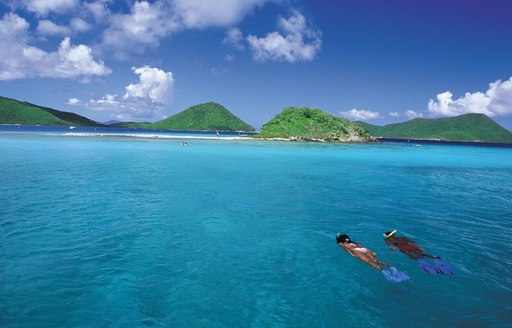 Couple snorkelling in the azure waters of the Caribbean