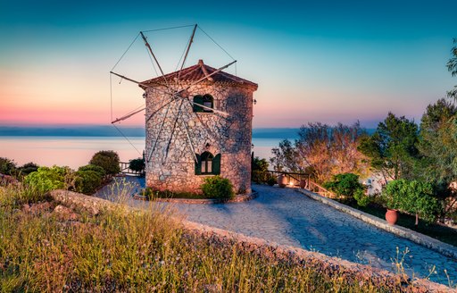 Cycladic Windmill on a hill at sunset