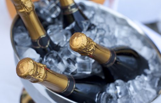 four bottles of champagne in an ice bucket