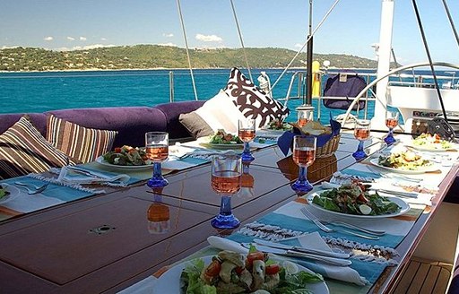 Alfresco dining setup on the deck of sailing yacht charter DARK STAR OF LONDON