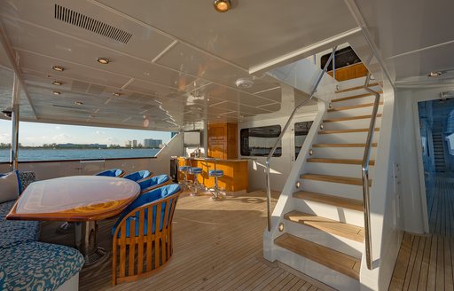 Charter yacht I LOVE THIS BOAT exterior with staircase and dining table