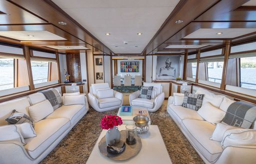 Charter yacht BUNKER main salon lounge area with plush sofas