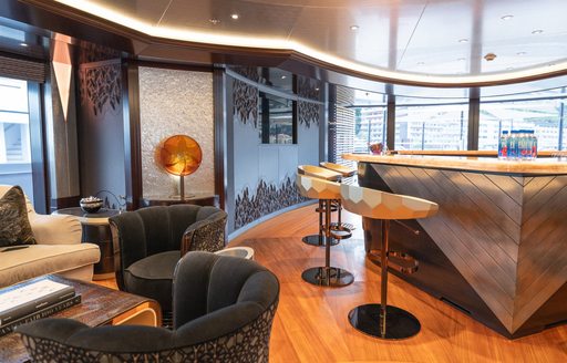 Wet bar and armchair arrangement onboard charter yacht WHISPER 