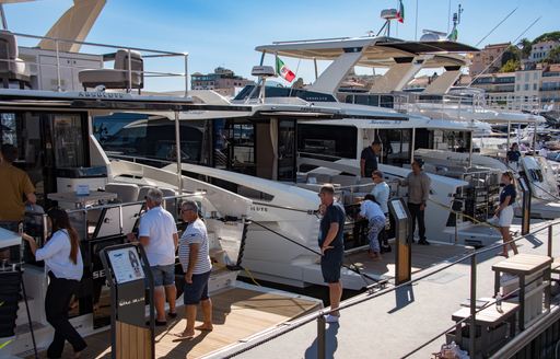 Motor yachts and visitors at the Cannes Yachting Festival