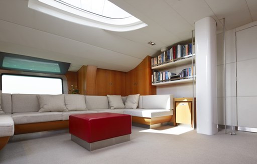 Light streaming in to white and red interior of charter yacht SILVERTIP 