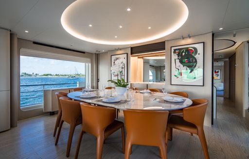 Interior dining area onboard charter yacht CARPE DIEM with adjacent window