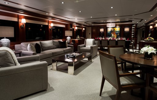 Grey furnishings and wood finishings found in the interior of superyacht W