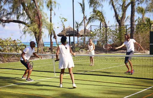 people play tennis on sports court on thanda island