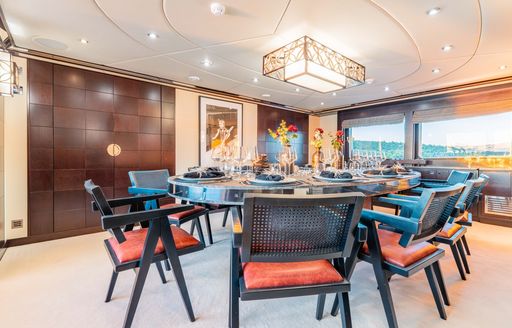 Charter yacht VICTORY interior circular dining table chair and chairs