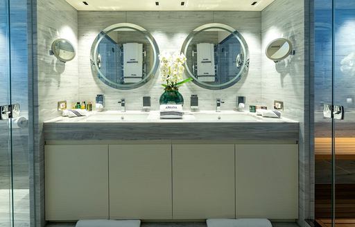 En suite facility with dual sinks and twin mirrors onboard charter yacht ARSANA