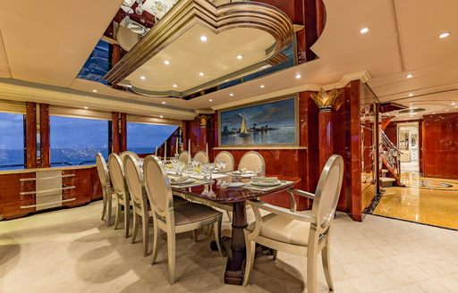 Charter yacht I LOVE THIS BOAT interior dining area with long table and cream seating