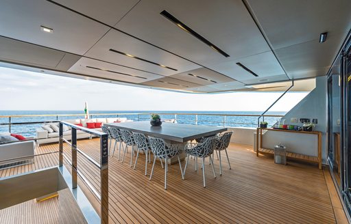 alfresco dining arrangement on deck of tecnomar yacht giraud