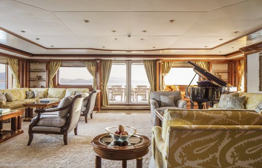 Main salon on board charter yacht TITANIA, with grand piano in background