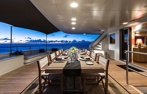 alfresco dining as the sun sets on upper deck aft luxury yacht MARIU 