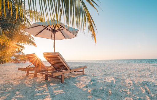 Chairs on the sandy beach near the sea in Bahamas